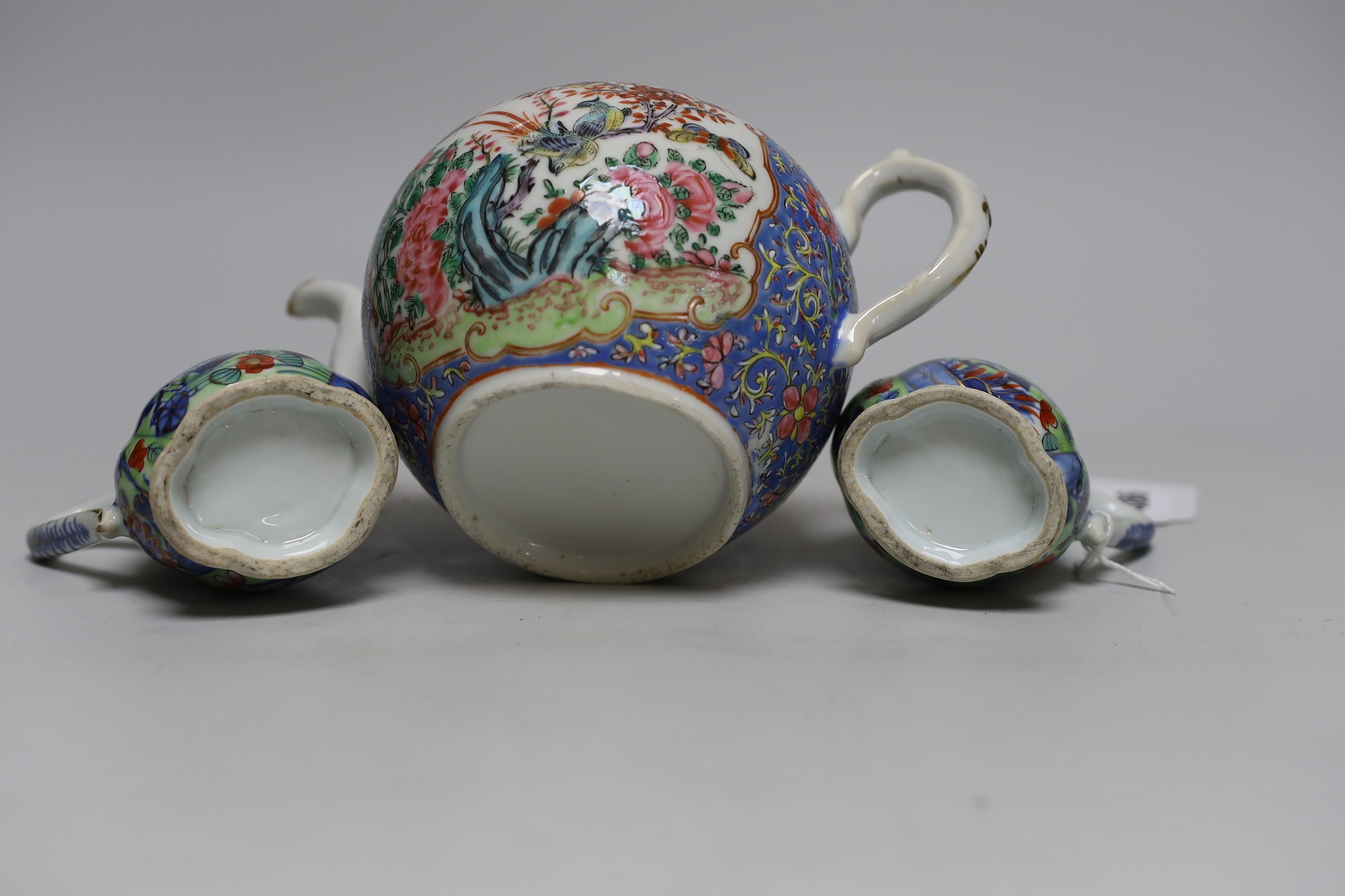 Two Chinese Kangxi clobbered jugs and covers, and a 19th century famille rose teapot, 13cms high